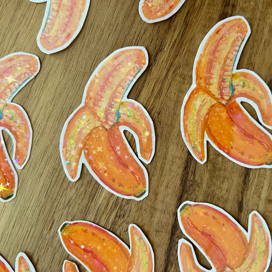 Banana-shaped stickers on a wooden surface