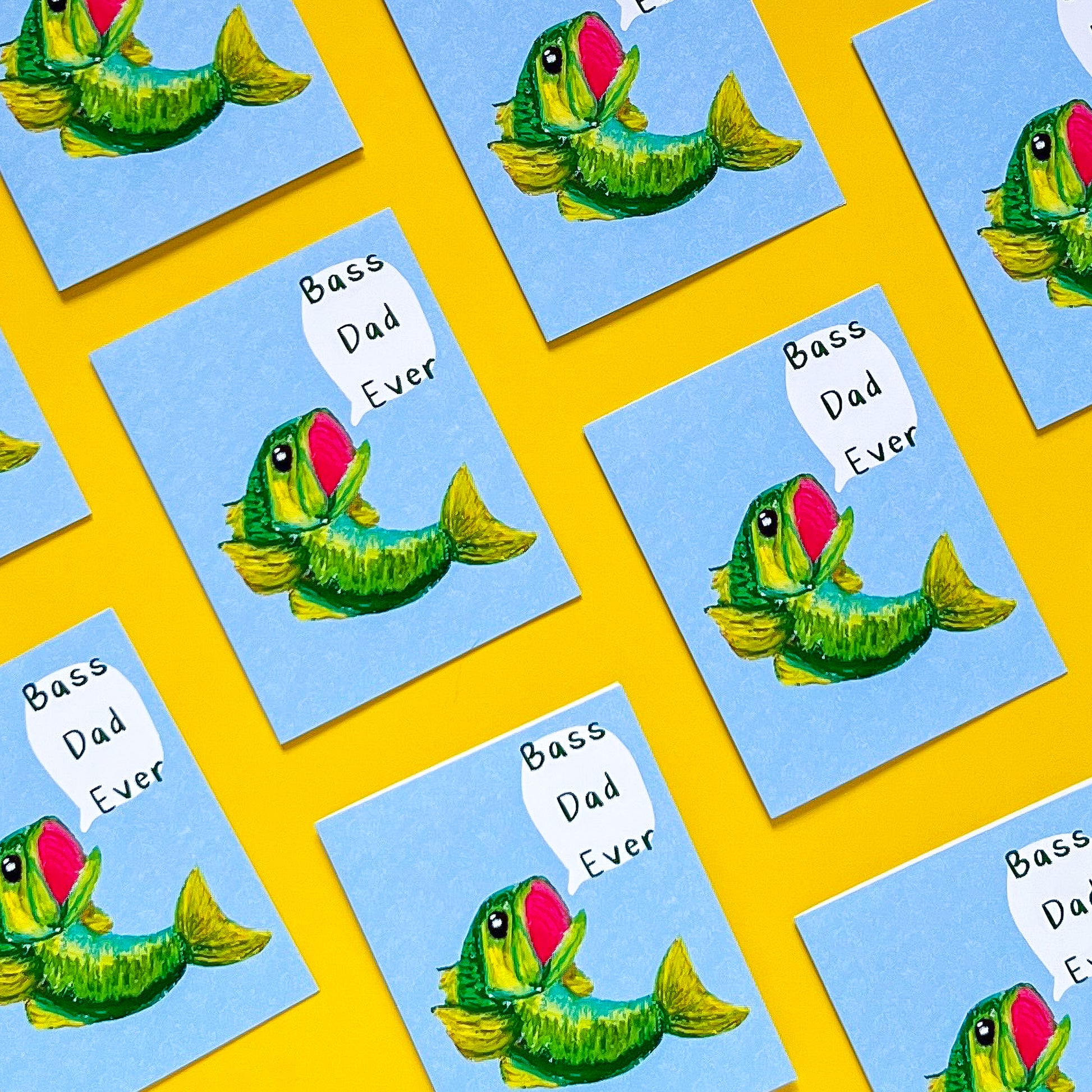 greeting cards with design of a bass fish and text 'bass dad ever' on it with yellow background
