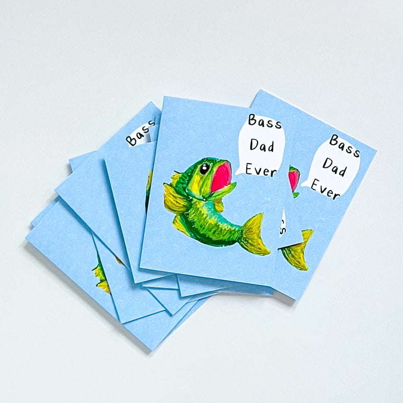 stack of bass dad ever greeting cards on a white background