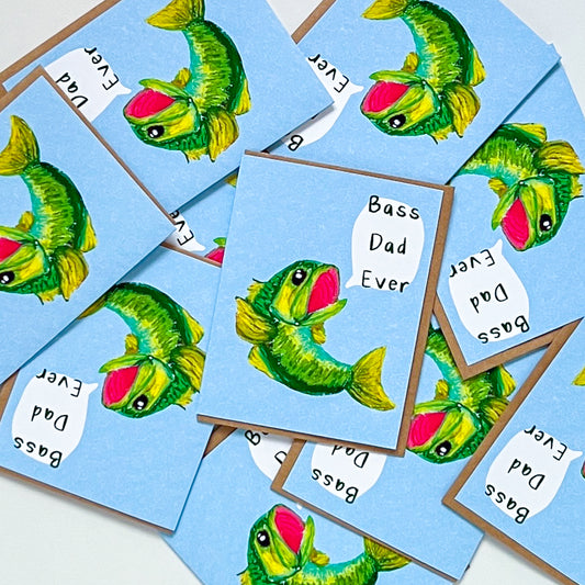 a stack of greeting cards with design of a bass fish and text 'bass dad ever' on it with white background