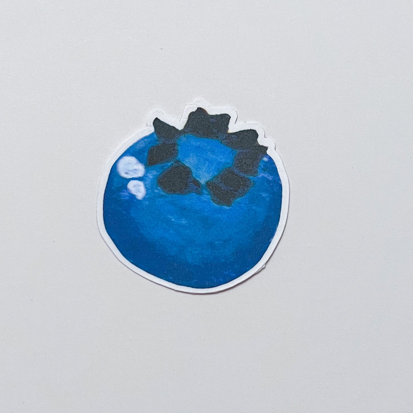 Sticker of a blueberry on a gray background