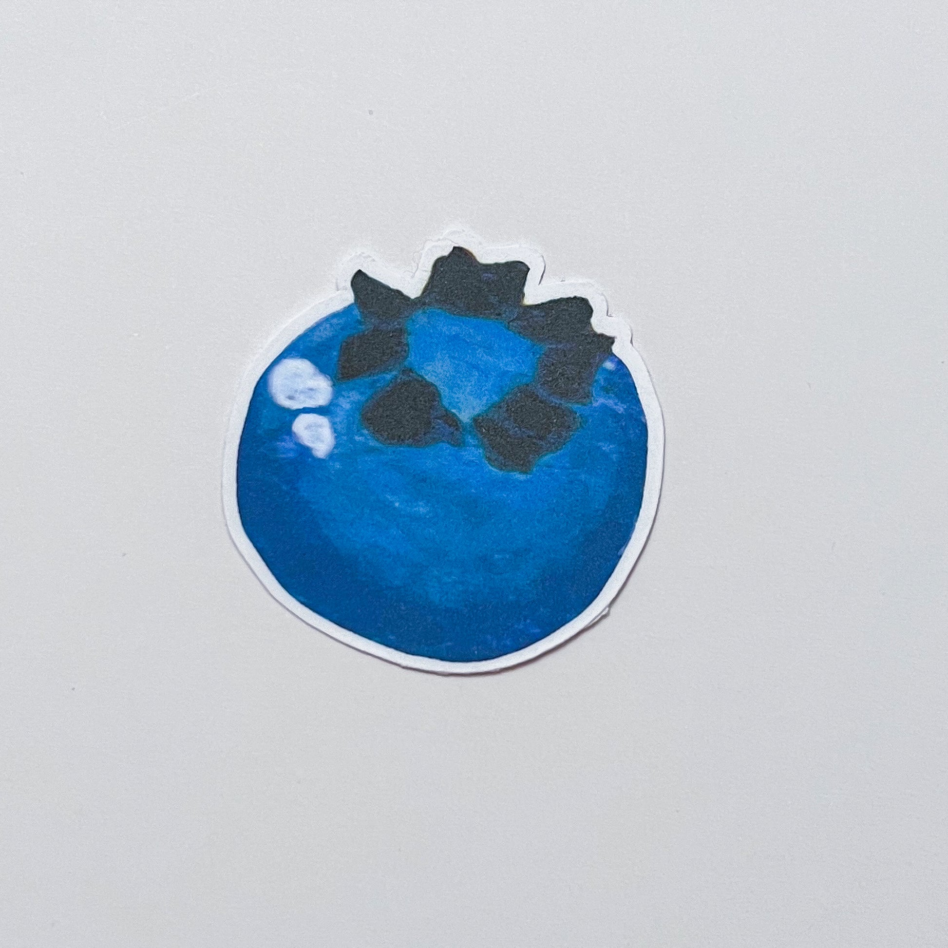 Sticker of a blueberry on a gray background