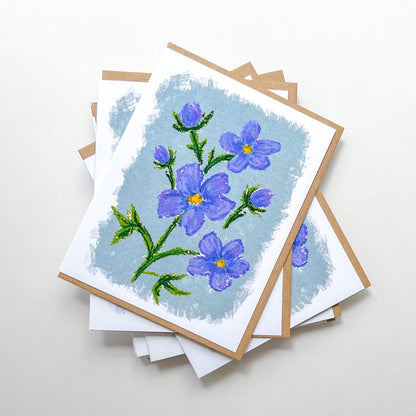 greeting cards with an oil pastel drawing of a blue flowers