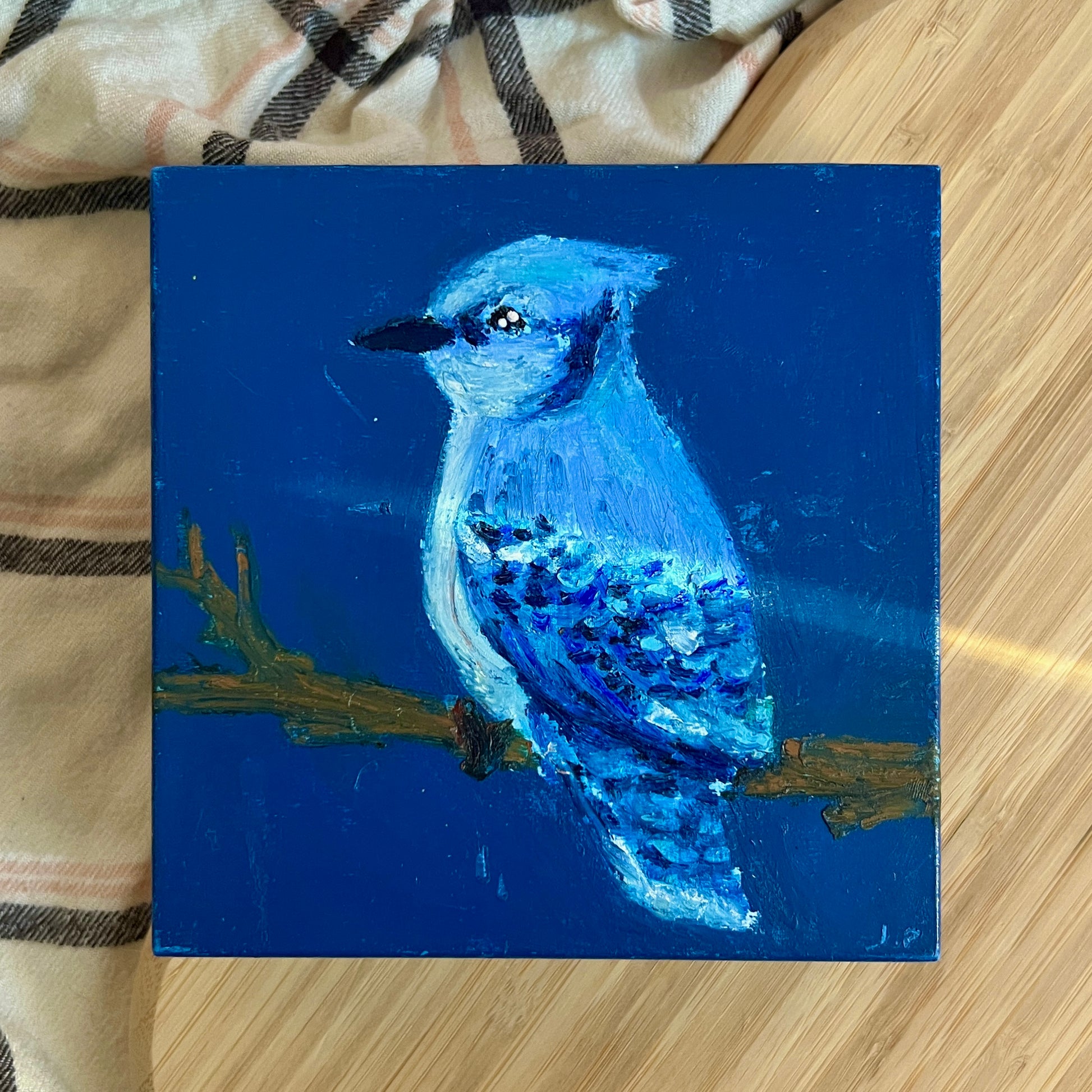 Painting of a blue bird on a blue background