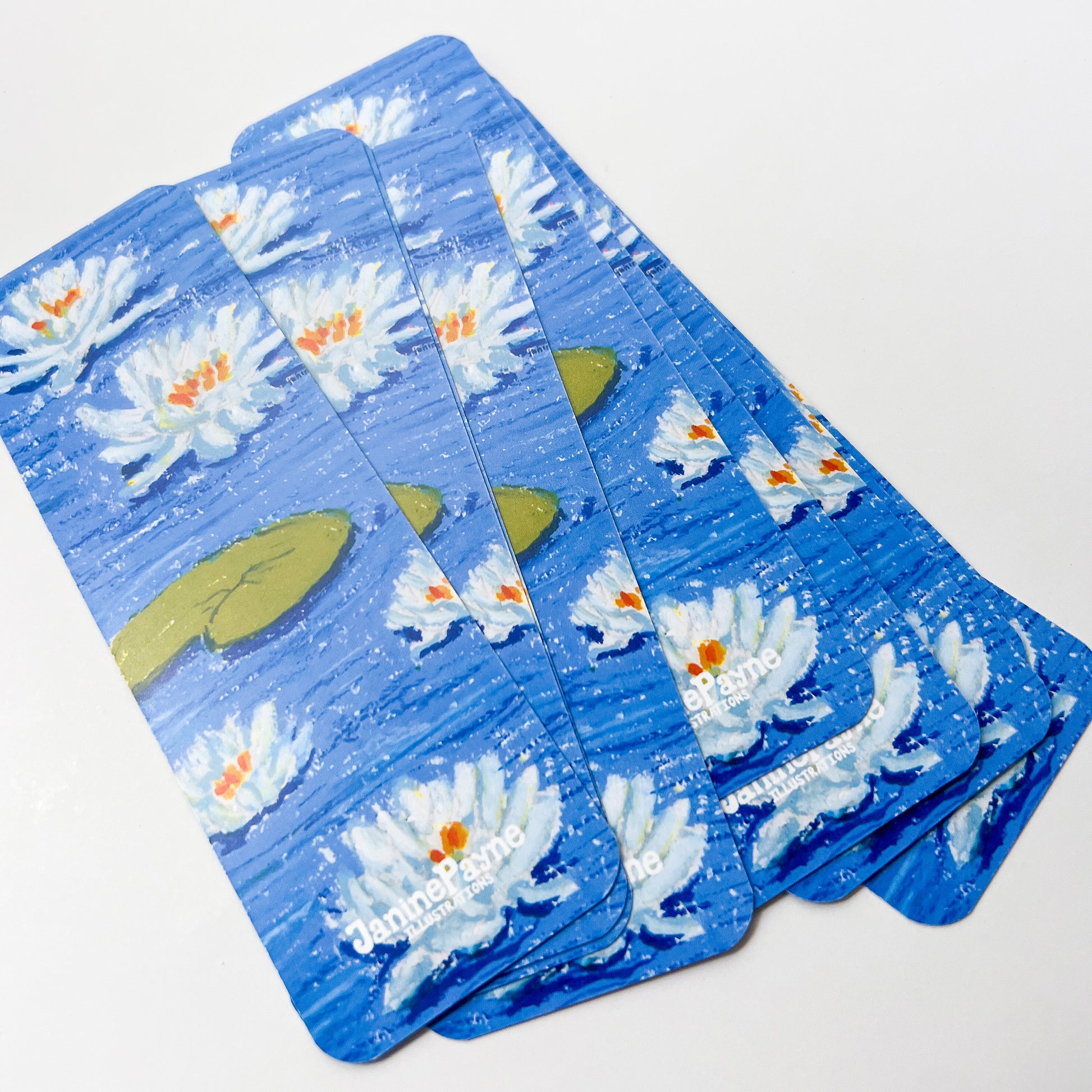 Set of bookmarks with white flowers and green leaves on a white background