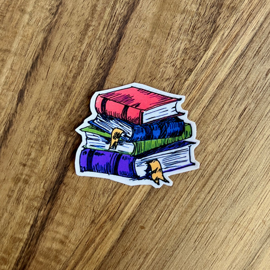 Colorful sticker of a stack of books on a wooden surface