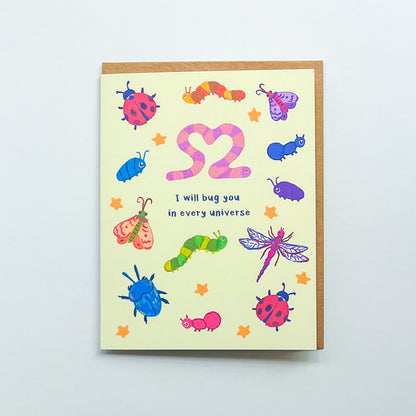 Greeting card with colorful insect illustrations and text 'I will bug you in every universe' on a light gray background
