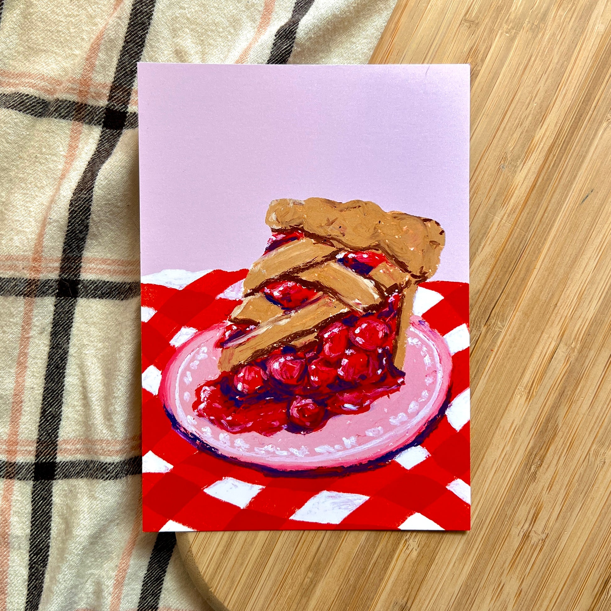 illustration of cherry pie on red checkered cloth 
