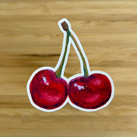 Sticker of two cherries on a wooden background