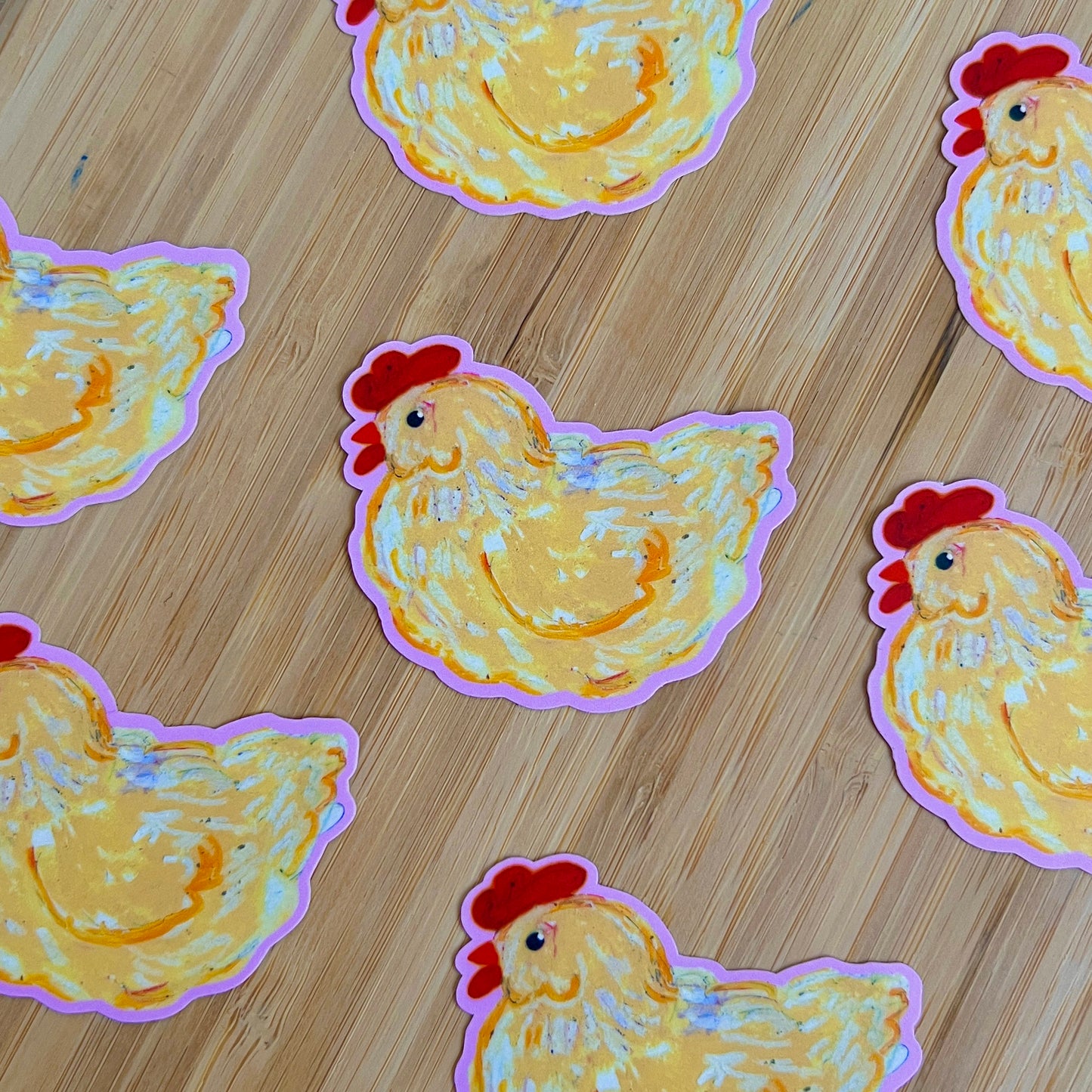 Stickers of chickens on a wooden surface