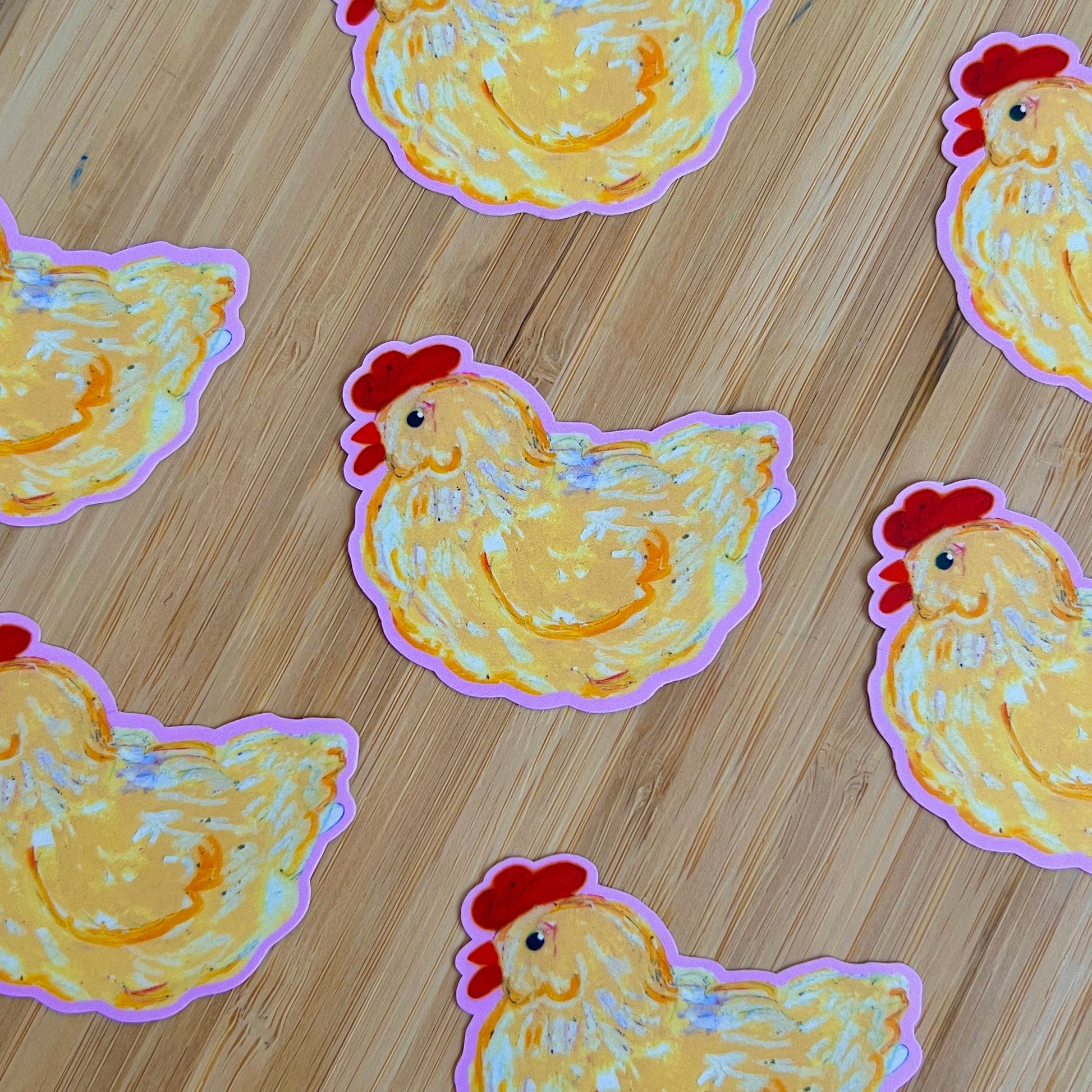 Stickers of chickens on a wooden surface