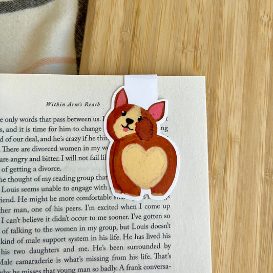 Dog-shaped bookmark on a book with a wooden surface in the background