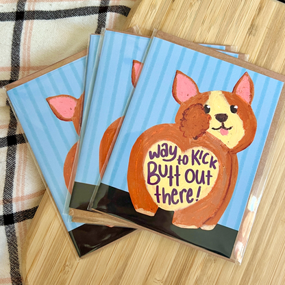 three carda with a drawn corgi with heart shaped butt on a blue striped background with text 'way to kick butt out there'