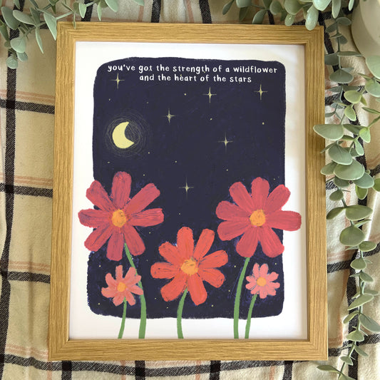 Framed artwork with red flowers and motivational quote on a starry night background.