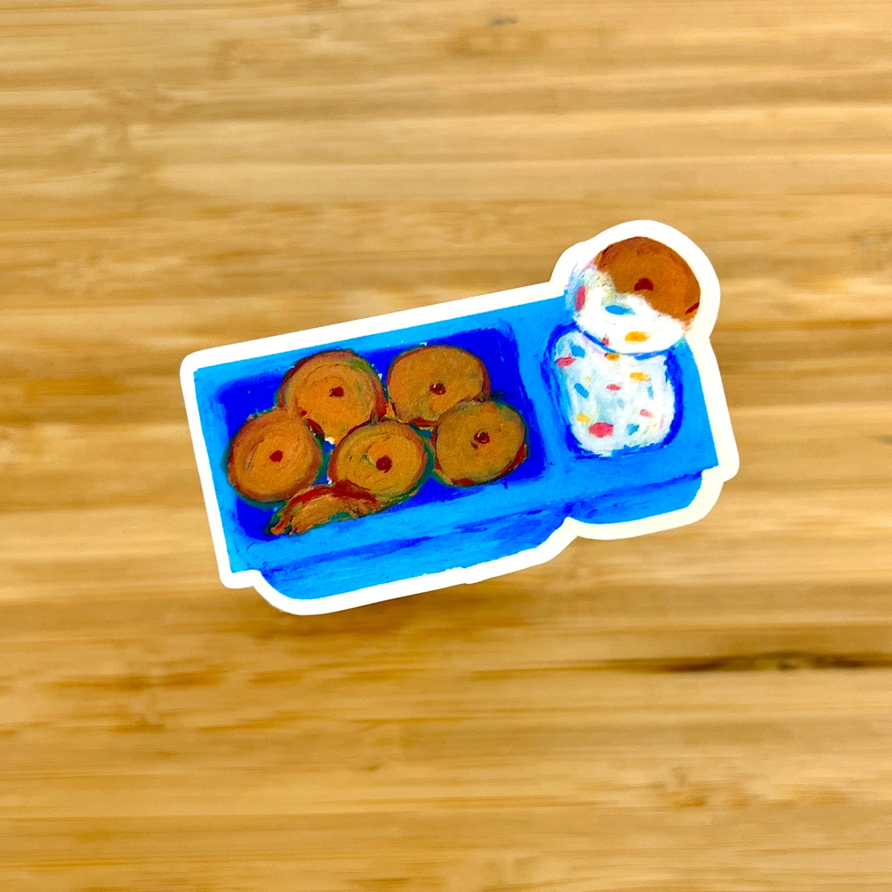 Illustration of a blue tray with cookies and a cake on a wooden surface