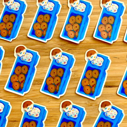 Stickers of blue lunch boxes with cookies and ice cream on a wooden surface