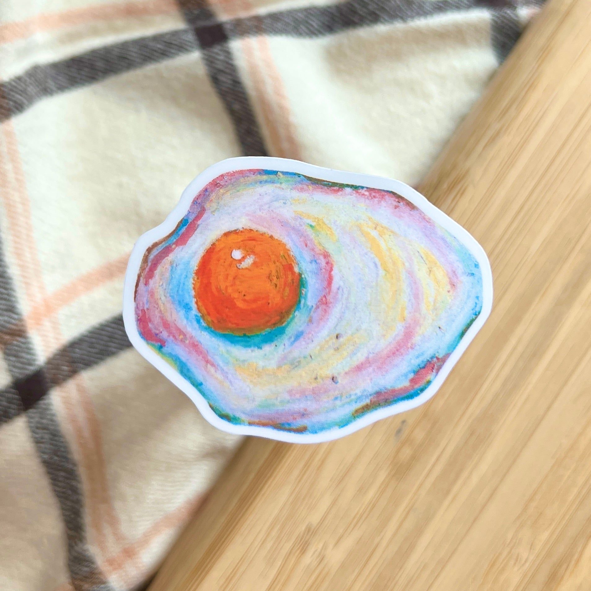 egg sticker on plaid and wooden background