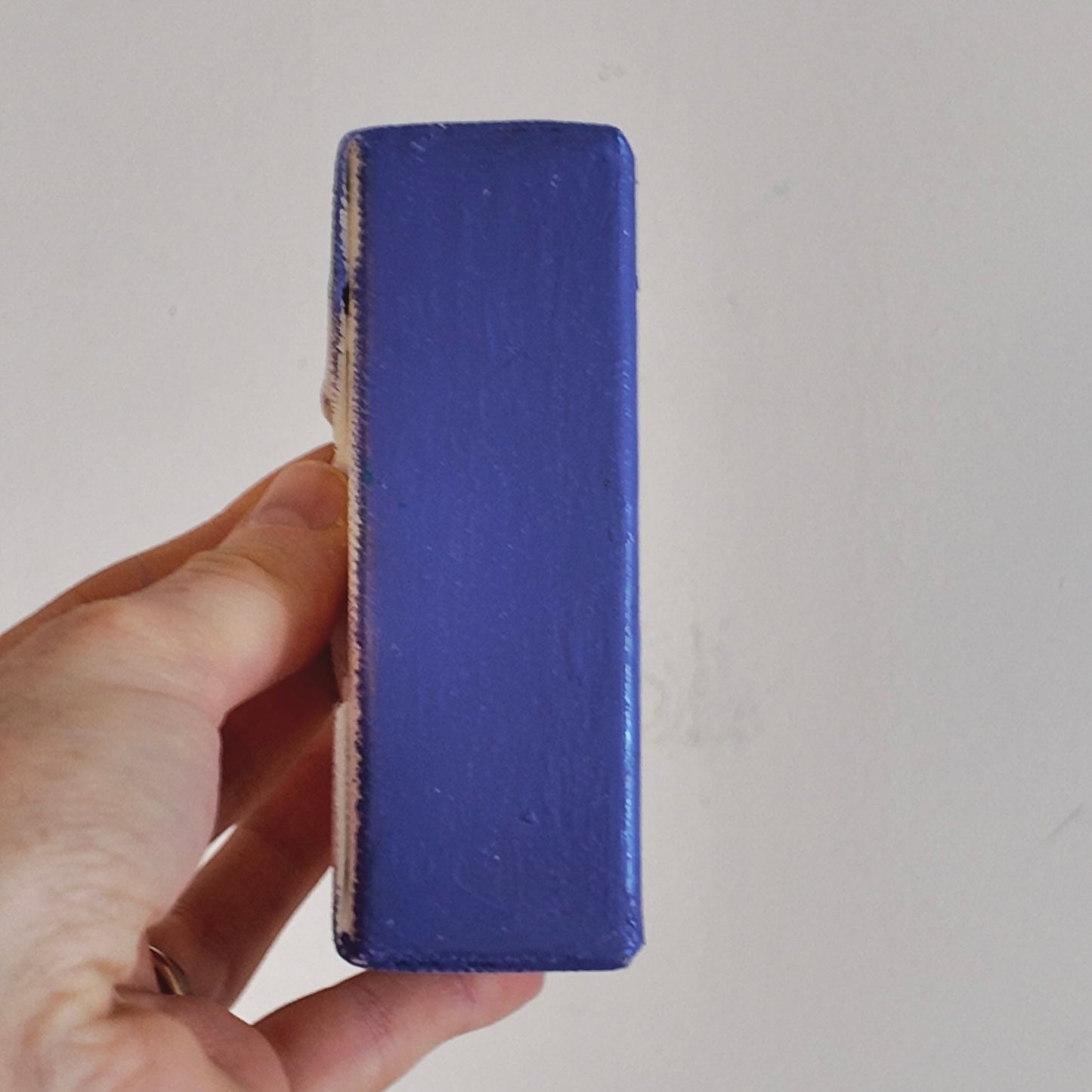 hand holding a side profile of purple canvas