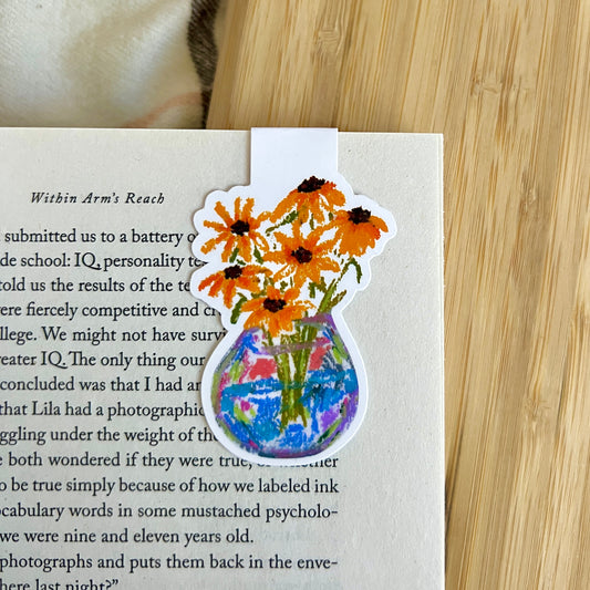 Floral bookmark with a vase of flowers on a book page