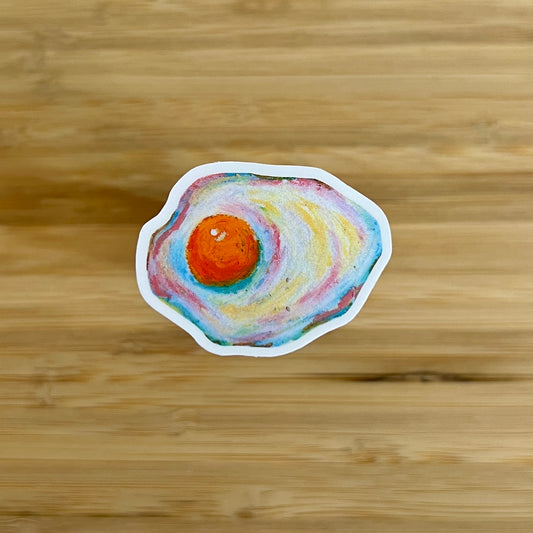 Colorful fried egg sticker on a wooden surface