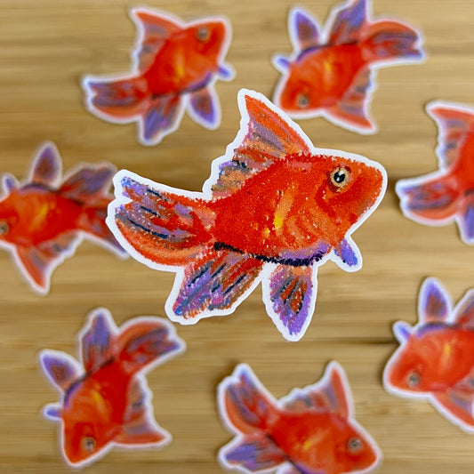 Goldfish stickers on a wooden surface
