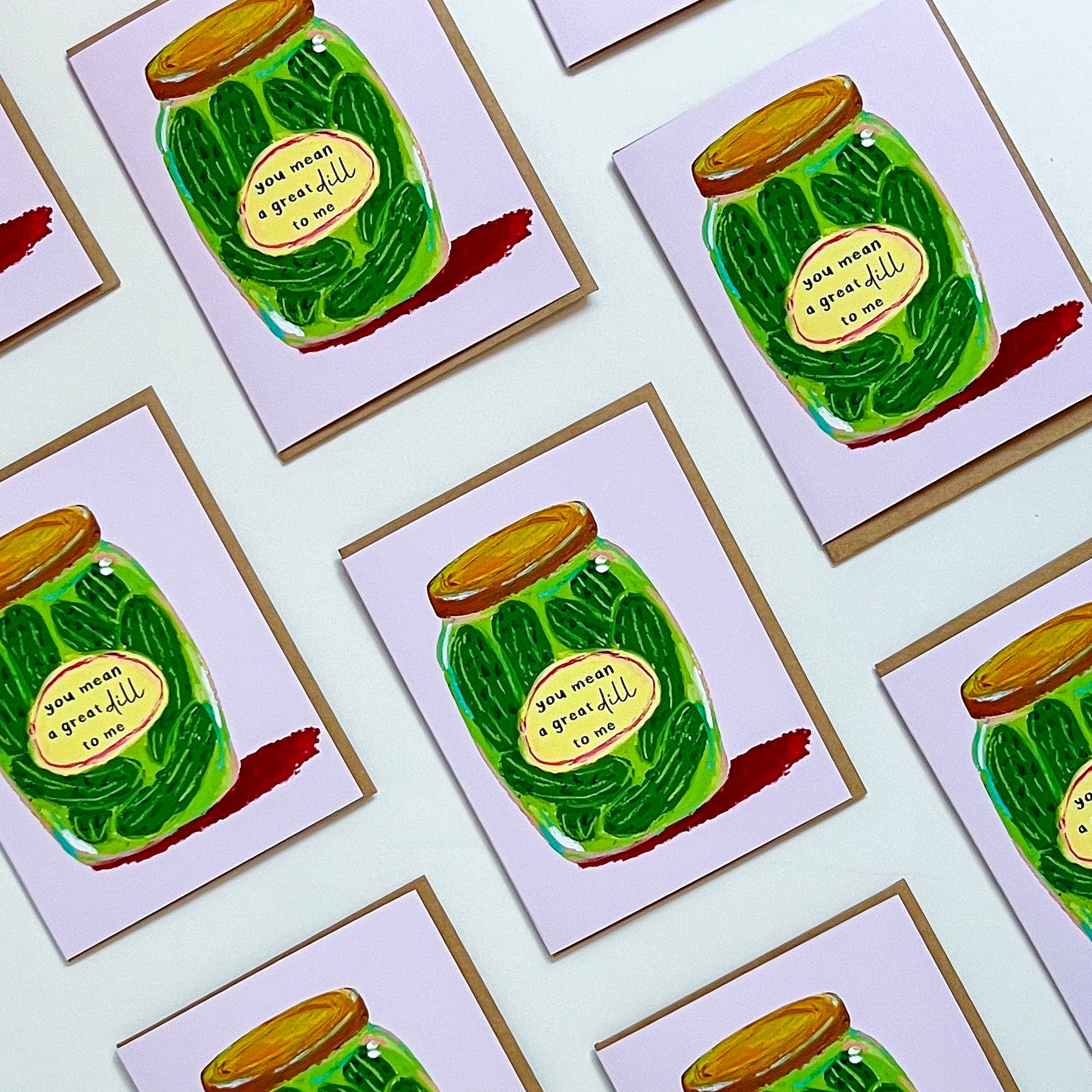 Multiple greeting cards with a green jar of pickles design on a white background