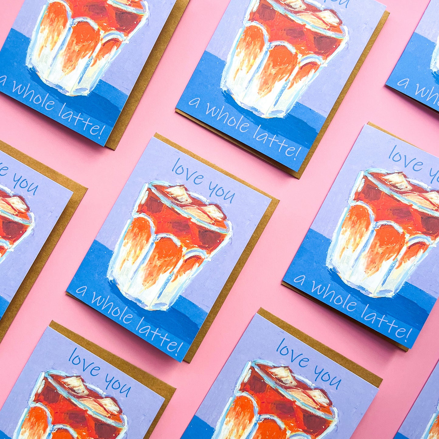 pattern of greeting cards with a drawing of an iced latte and text 'love you a whole latte!' on a pink background