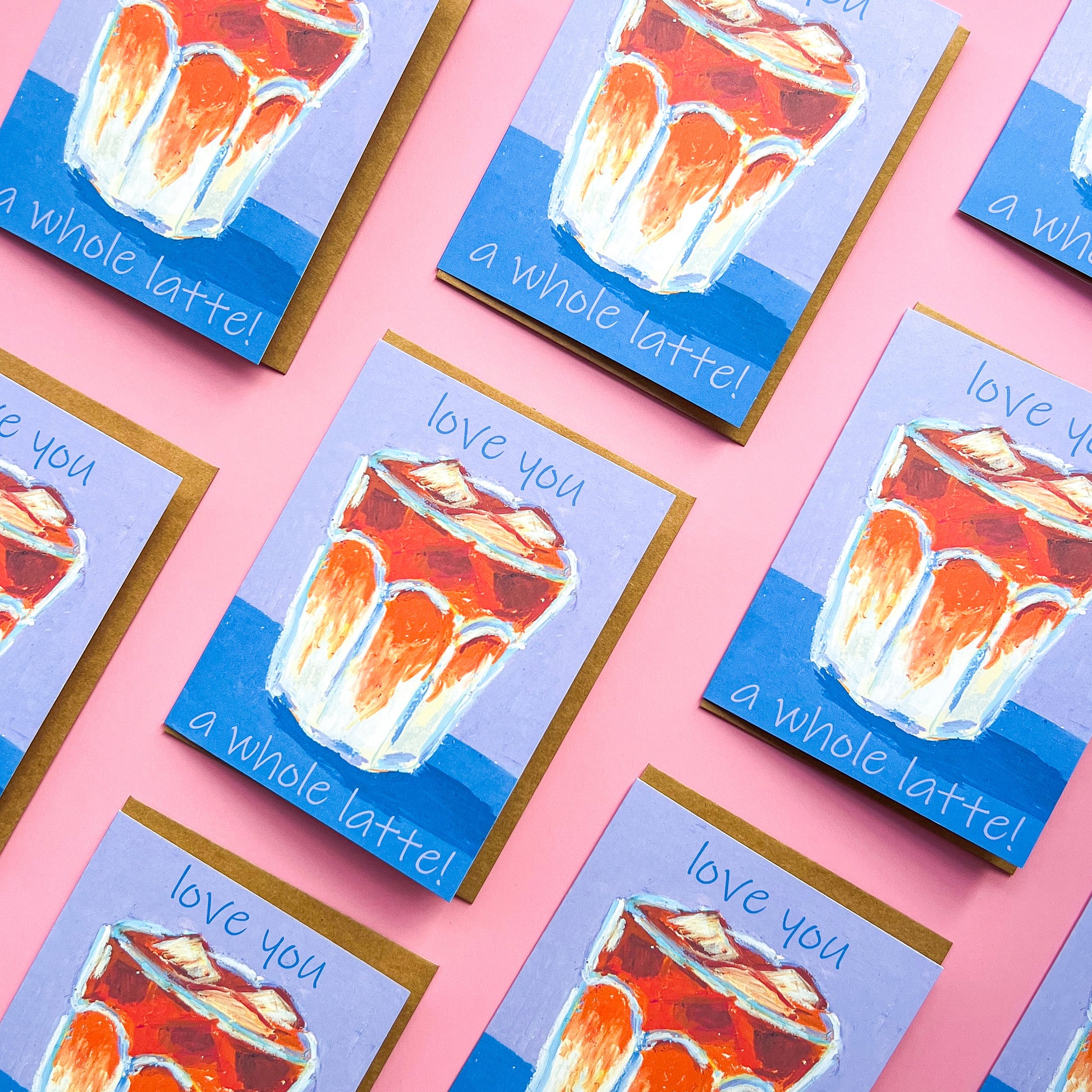 pattern of greeting cards with a drawing of an iced latte and text 'love you a whole latte!' on a pink background