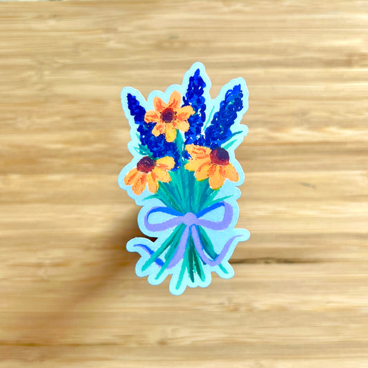 Sticker of a bouquet of flowers with a bow on a wooden surface