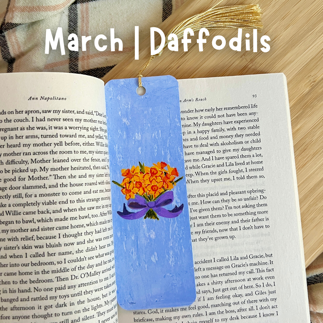 Blue bookmark with daffodil design on a book, with 'March | Daffodils' text above.
