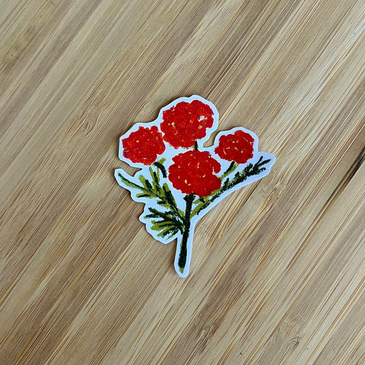 Sticker of red flowers on a wooden surface