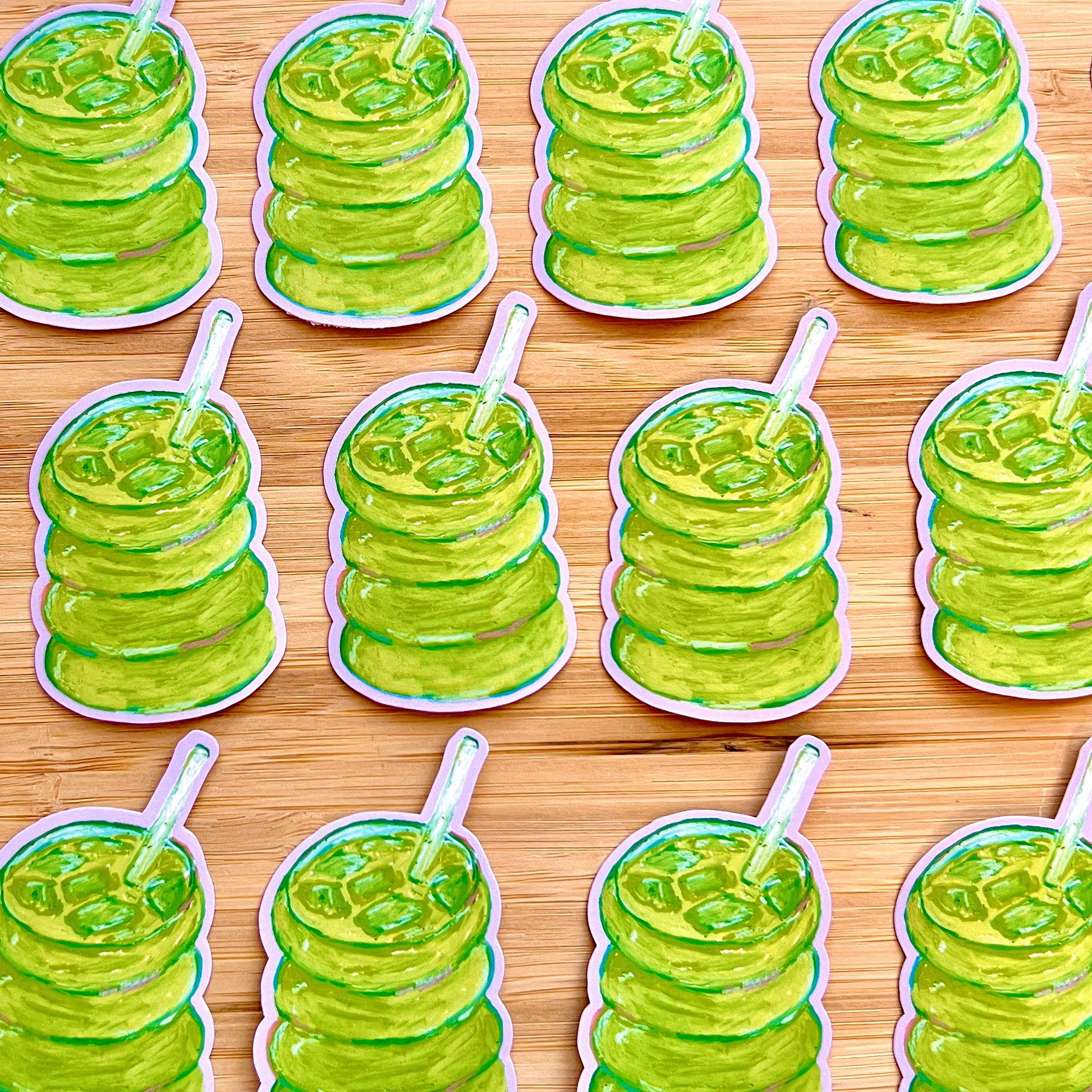 Multiple stickers of green matcha  on a wooden surface