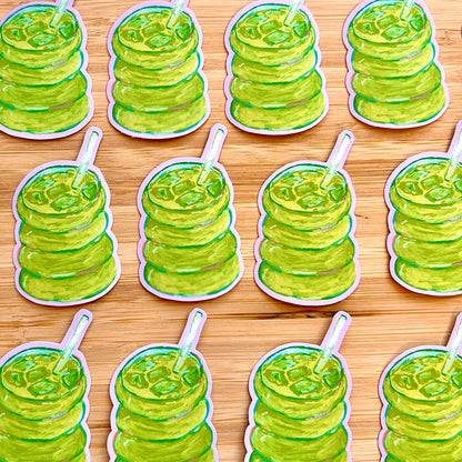 Multiple stickers of green matcha  on a wooden surface