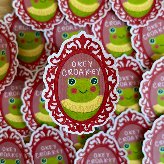 Sticker with a frog design and 'Okey Croak-ey' text, surrounded by similar stickers.