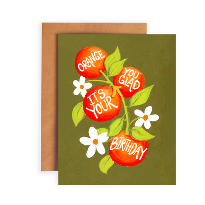 Greeting card with oranges and flowers on a green background, featuring text 'Orange you glad it's your birthday'.