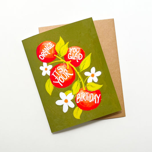 Greeting card with orange design and 'orange you glad It's Your Birthday' text on a white background