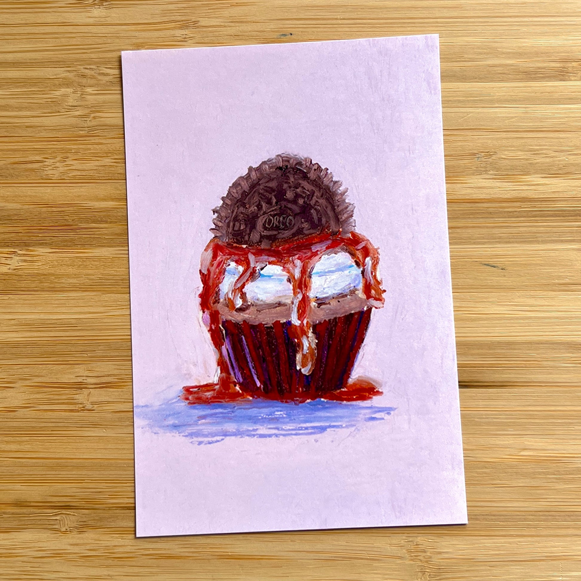 oreo cupcake with caramel sauce on a purple background