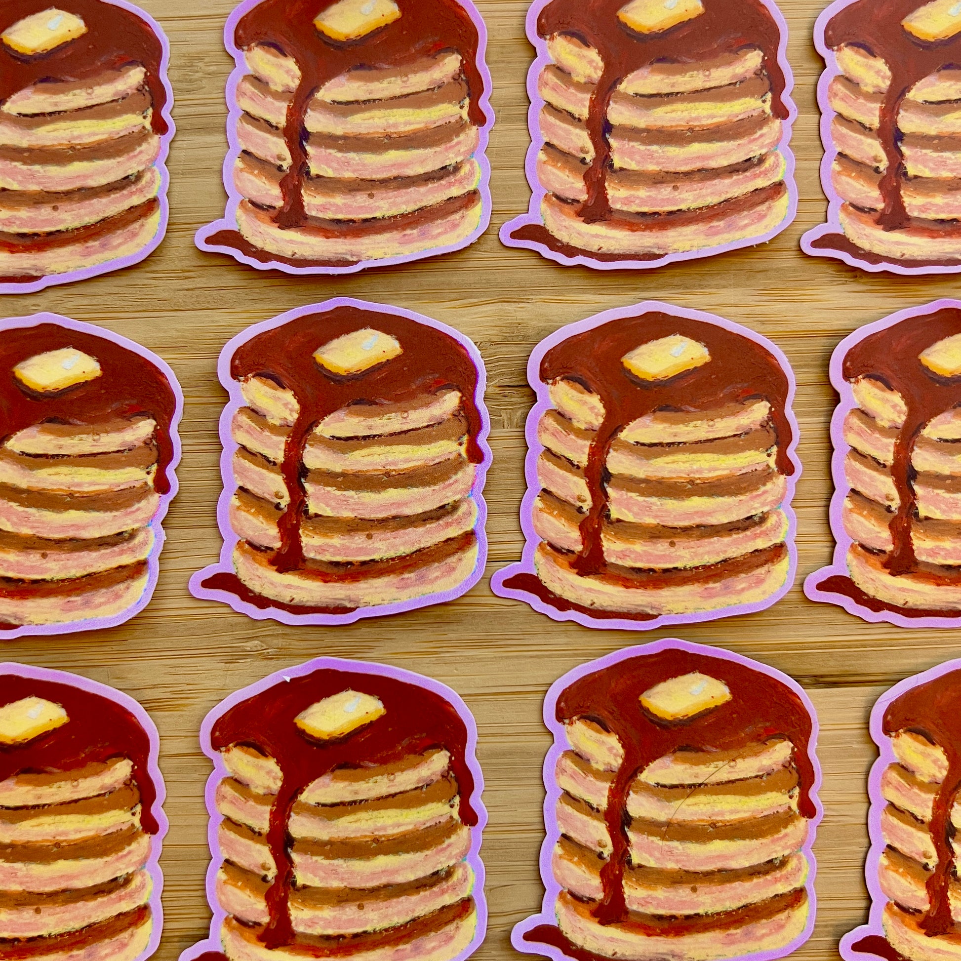 Illustrations of stacks of pancakes with syrup and butter on a wooden surface.
