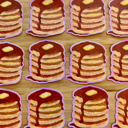 Illustrations of stacks of pancakes with syrup and butter on a wooden surface.
