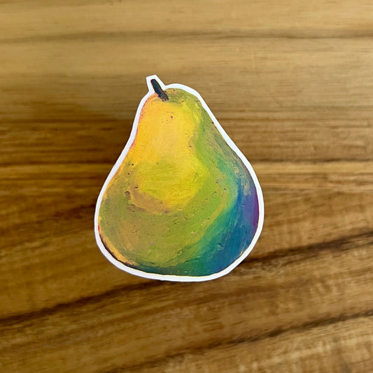 Colorful pear-shaped sticker on a wooden surface