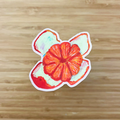 Colorful orange fruit stickert on a wooden surface