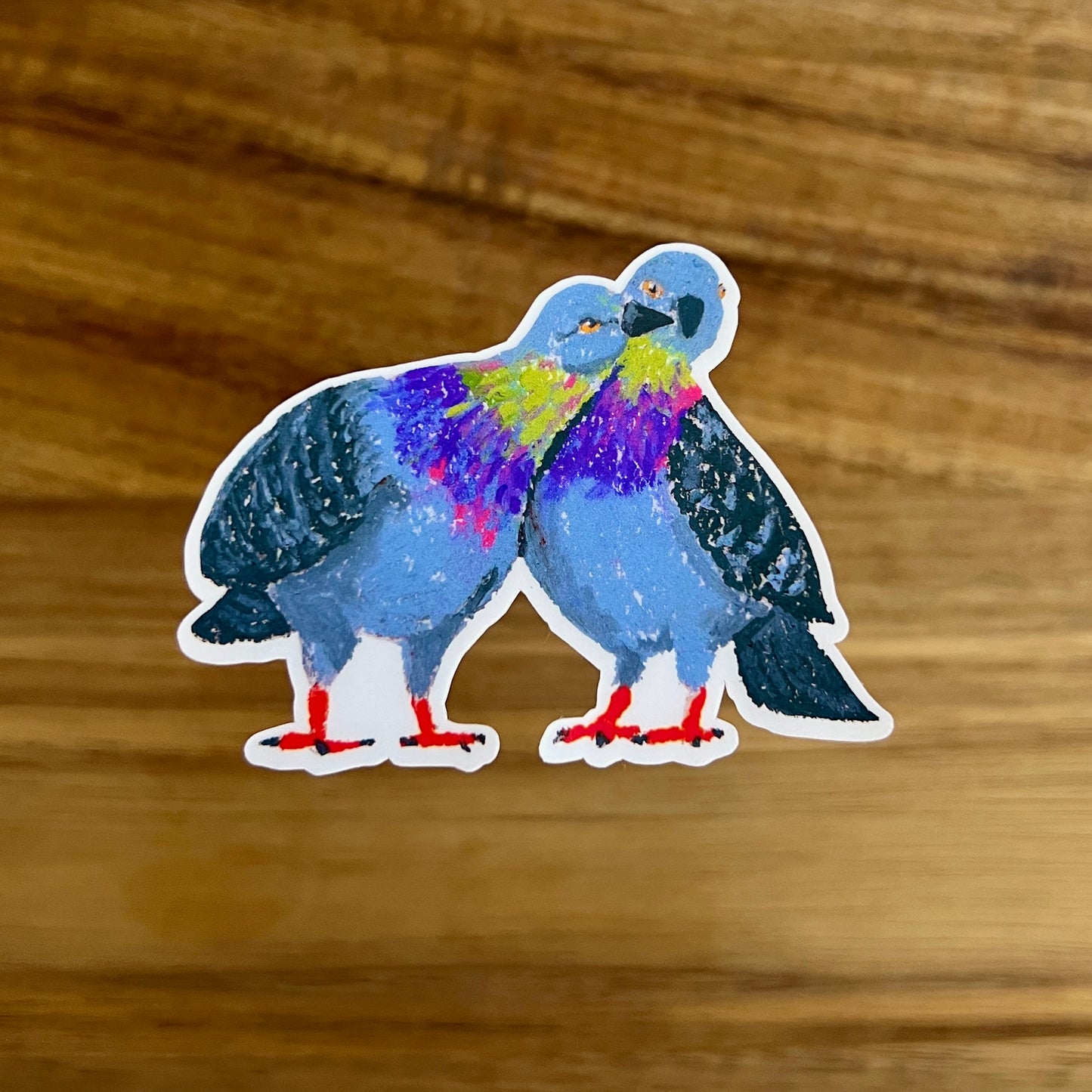 Colorful pigeons sticker on a wooden surface