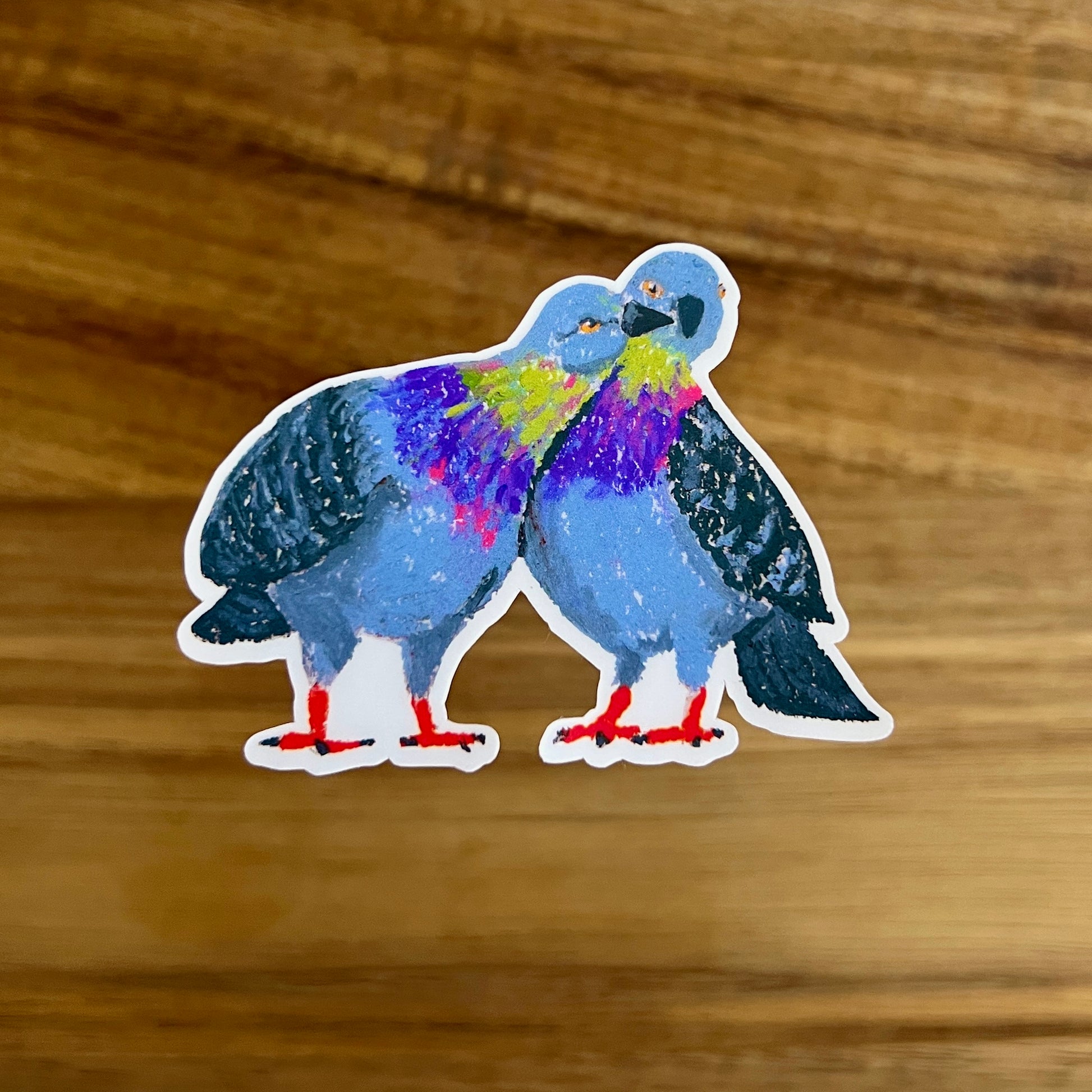 Colorful pigeons sticker on a wooden surface