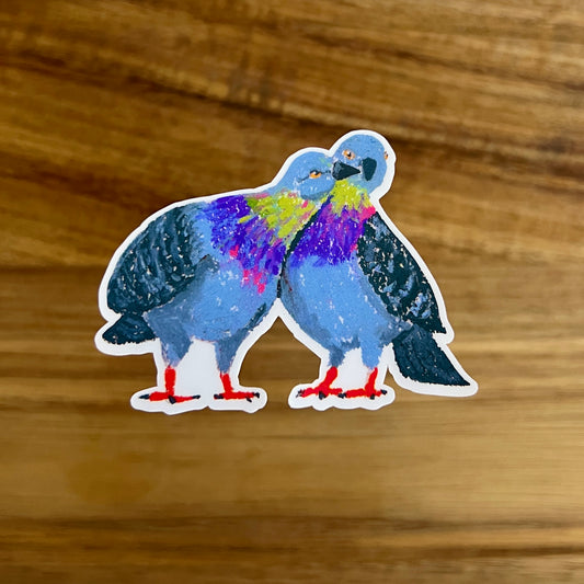 Colorful pigeons sticker on a wooden surface