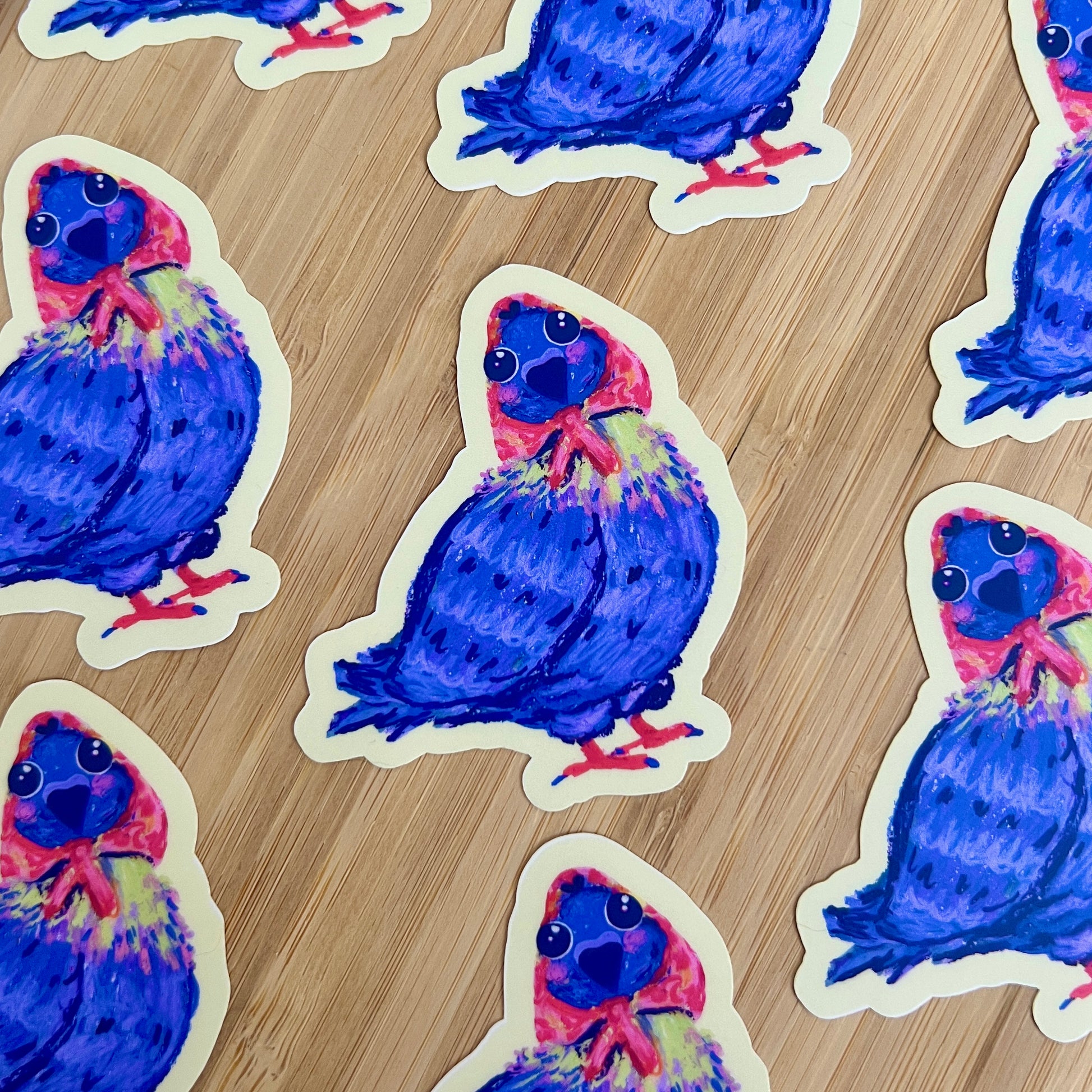 Stickers of a colorful bird design on a wooden surface
