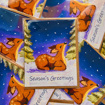 Season's Greetings card with a deer illustration on a snowy night background
