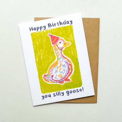 greeting card with illustration of a goose in a party hat and text 'happy birthday you silly goose'
