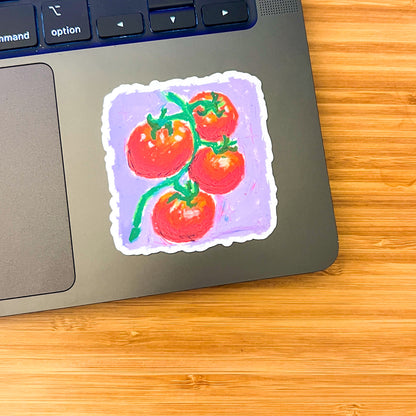 Sticker of tomatoes on a laptop keyboard
