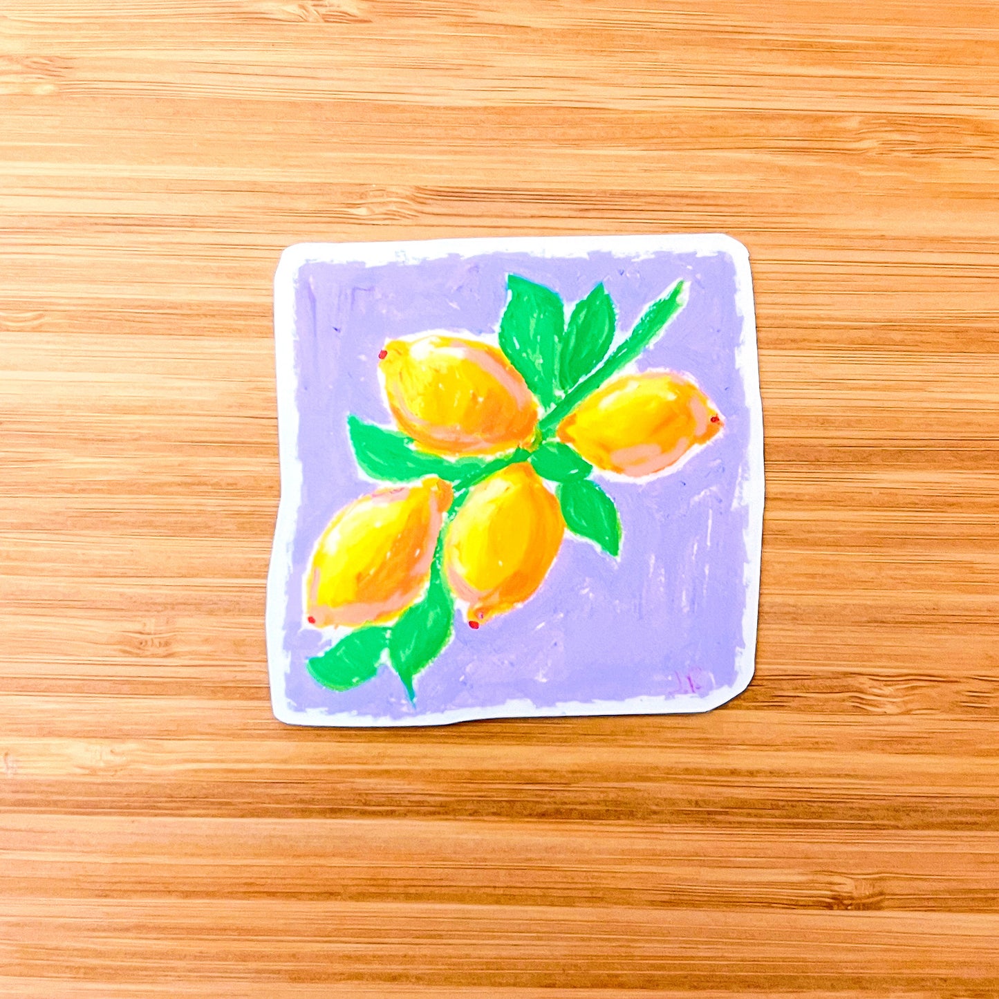 Sticker with a drawing of lemons on a wooden surface