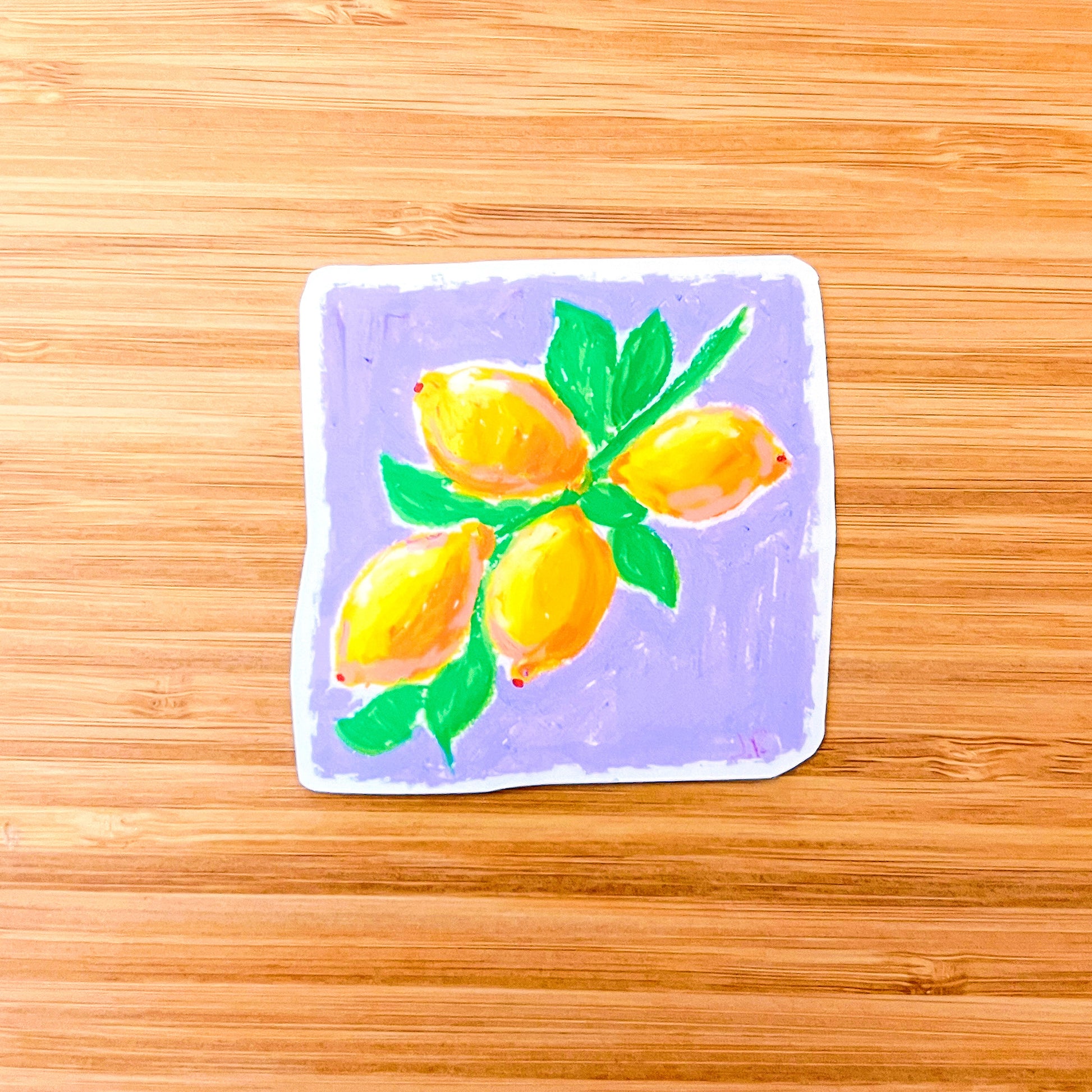 Sticker with a drawing of lemons on a wooden surface
